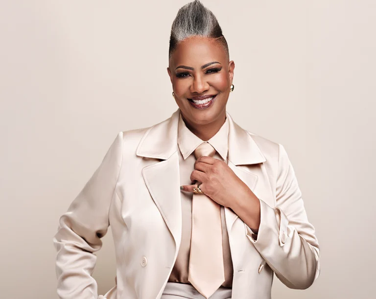 Professional dentist smiling in a studio portrait.