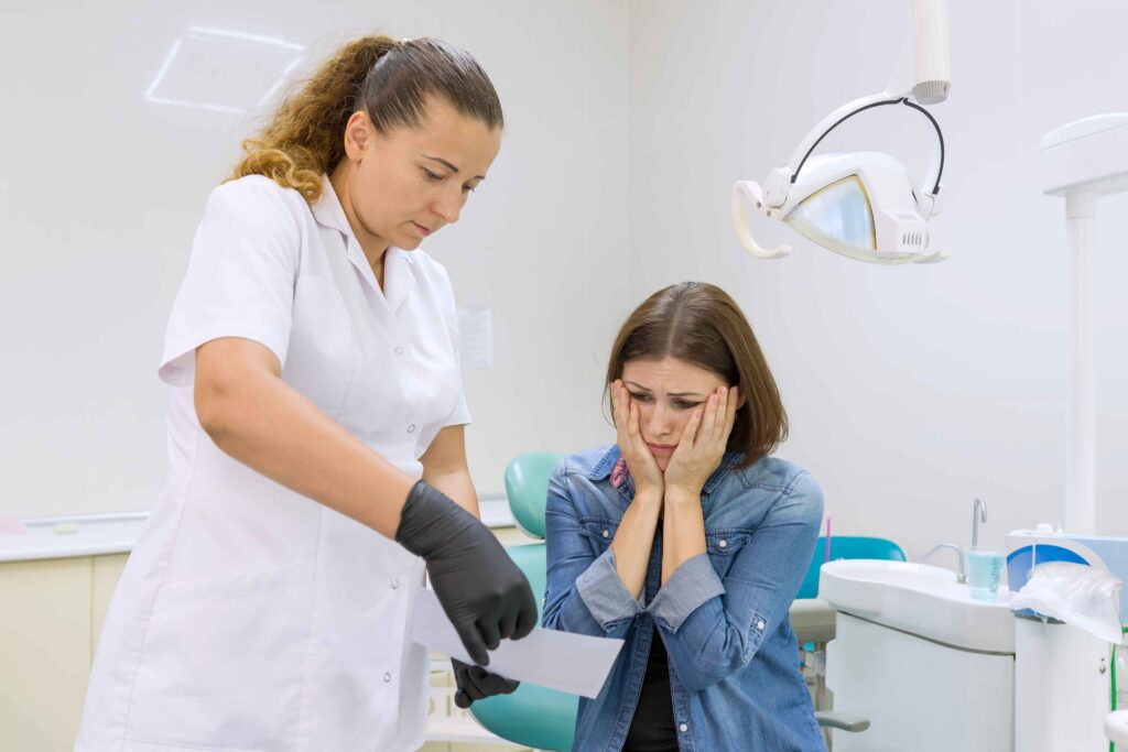 Dentist reviewing information with concerned patient