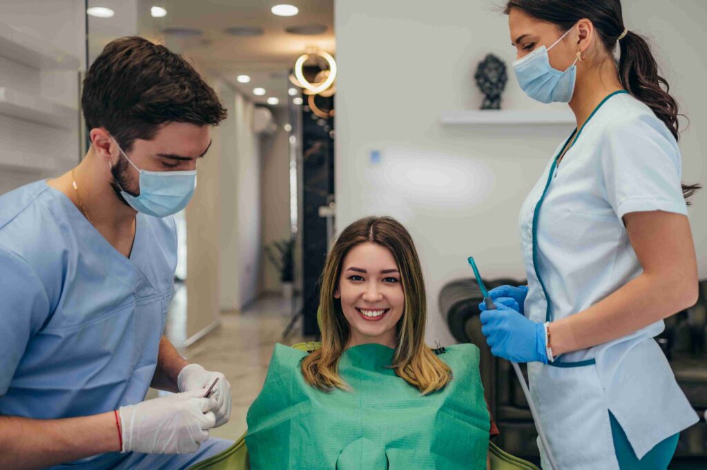Smiling patient seated with dental care team