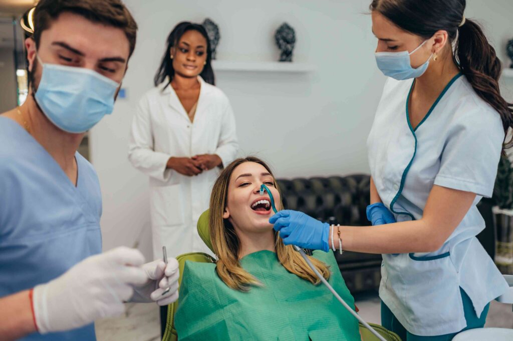 Dental team assisting patient during treatment