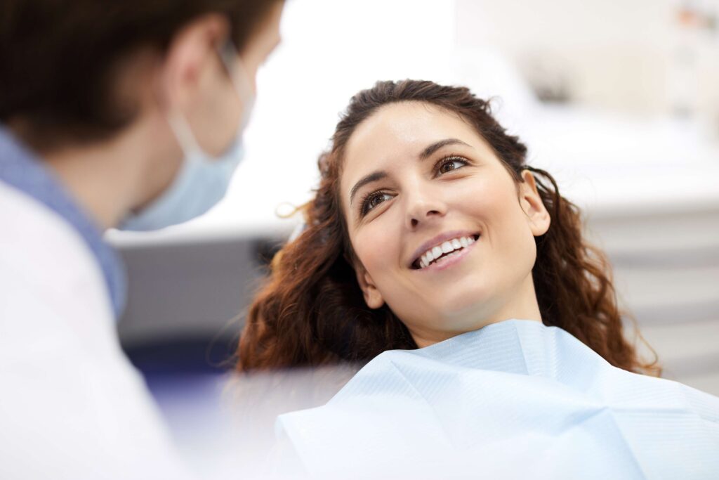 Patient smiling during consultation with dental provider