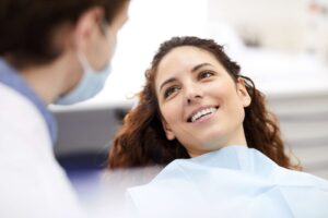 Patient smiling during consultation with dental provider