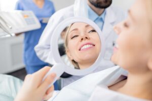 Patient checking smile results in a handheld mirror